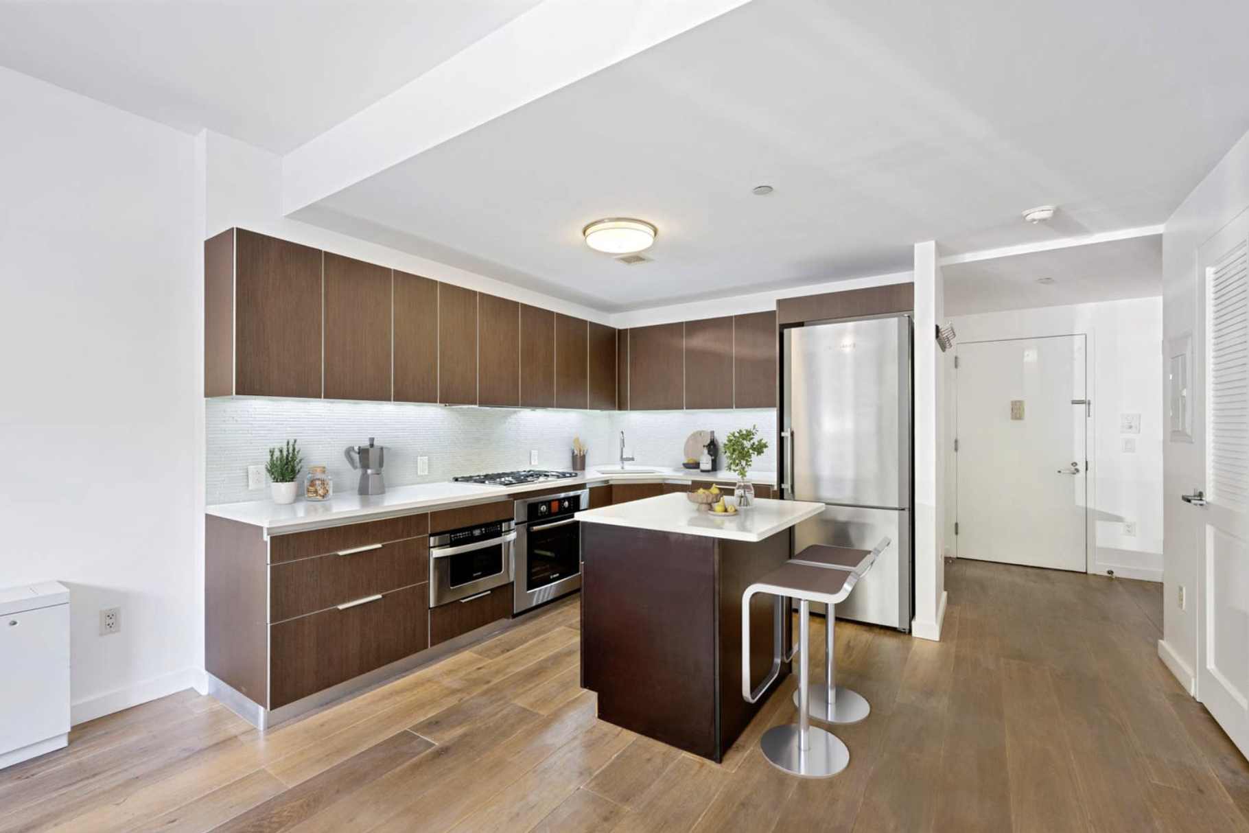 20 Henry Street, Unit 1CN Brooklyn, NY 11201 - Photo 2 of 9 a kitchen with stainless steel appliances granite countertop a stove top oven a sink dishwasher and white cabinets with wooden floor