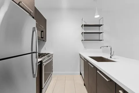 a kitchen with a sink and stainless steel appliances