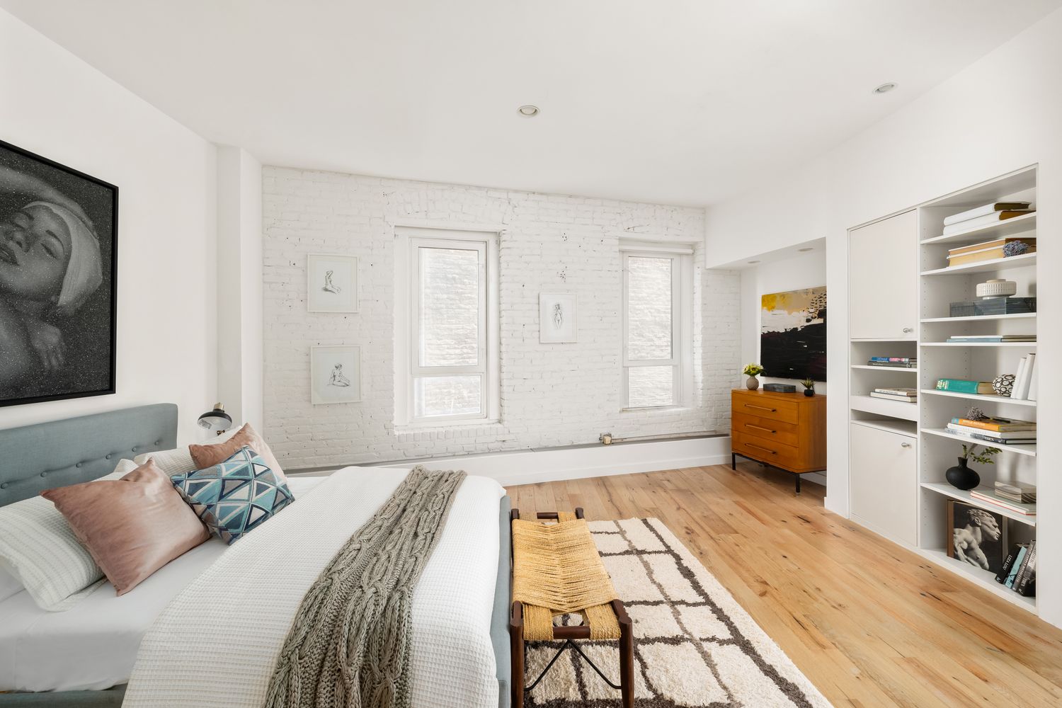 a bedroom with a bed and a television