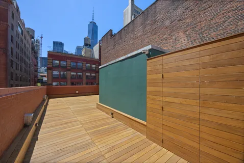 a view of a balcony with wooden floor and city view