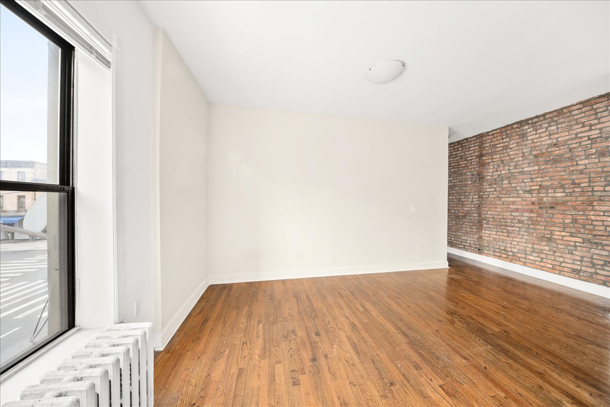 478 Halsey Street, Unit 1 Brooklyn, NY 11233 - Photo 3 of 10 a view of a room with wooden floor and a window