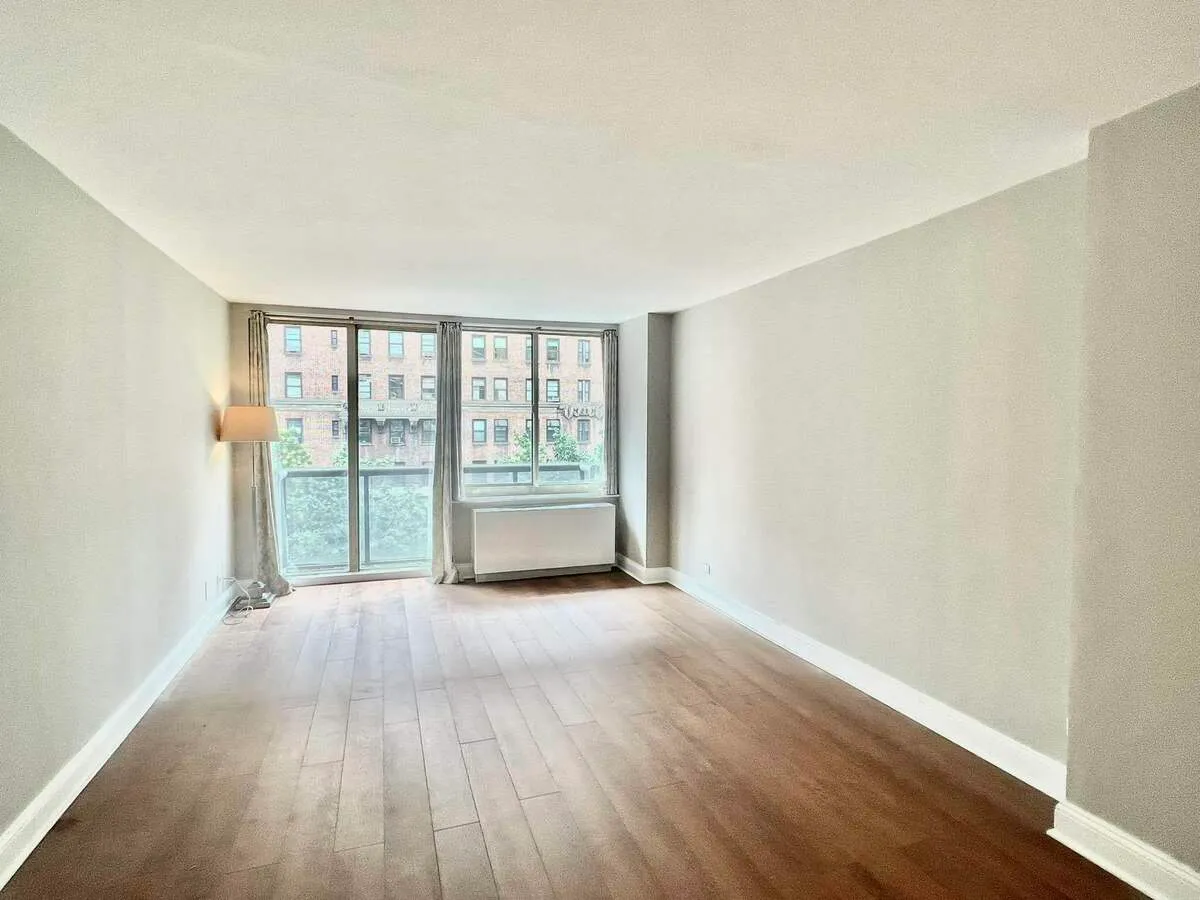 250 West 90th Street, Unit 6I Manhattan, NY 10024 - Photo 5 of 15 a view of an empty room with wooden floor and a window