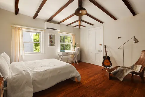 a bedroom with a bed window and table