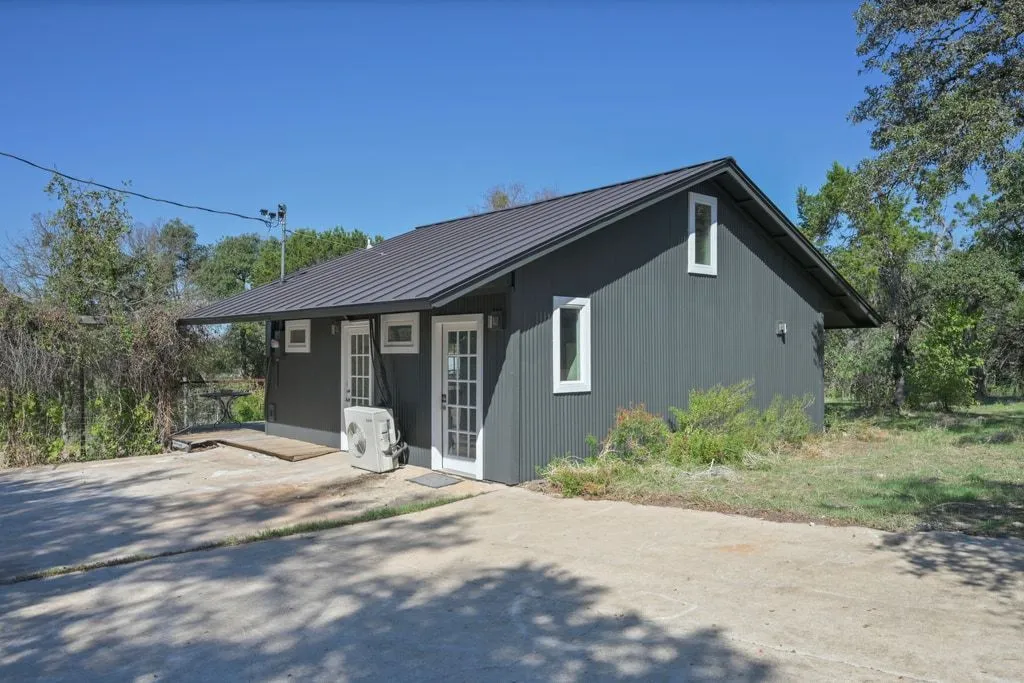 a front view of a house with yard and porch