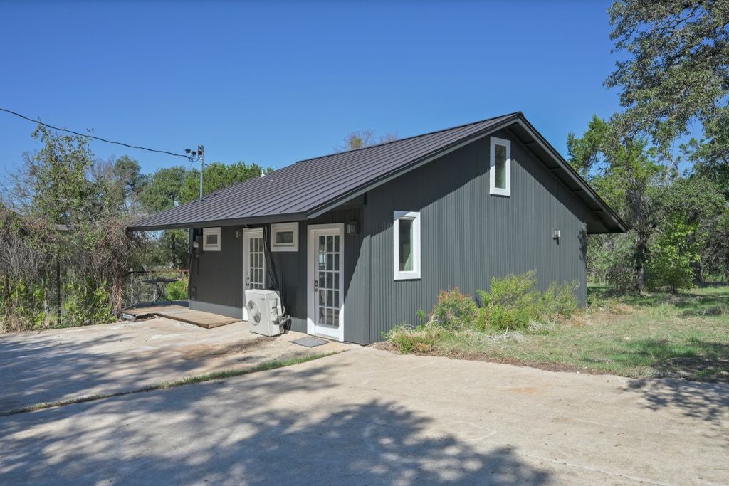 4416 Stearn's Lane Austin, TX 78735 - Photo 22 of 32 a front view of a house with yard and porch