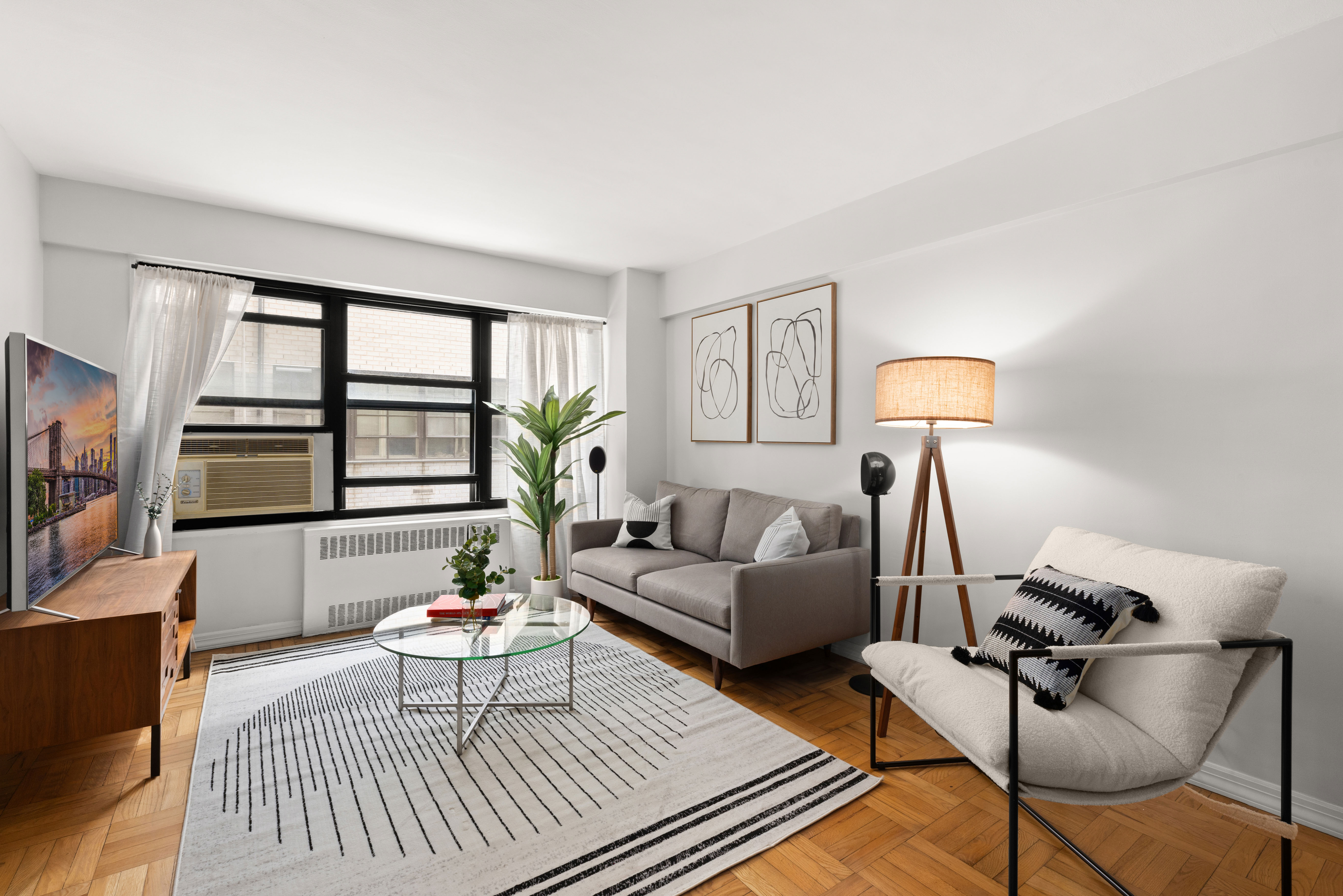 150 East 56th Street, Unit 2A Manhattan, NY 10022 - Photo 2 of 10 a living room with furniture and a window