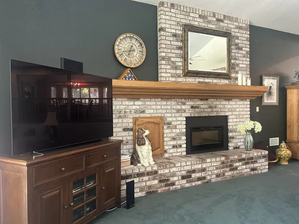 a patio with a table and chairs and potted plants