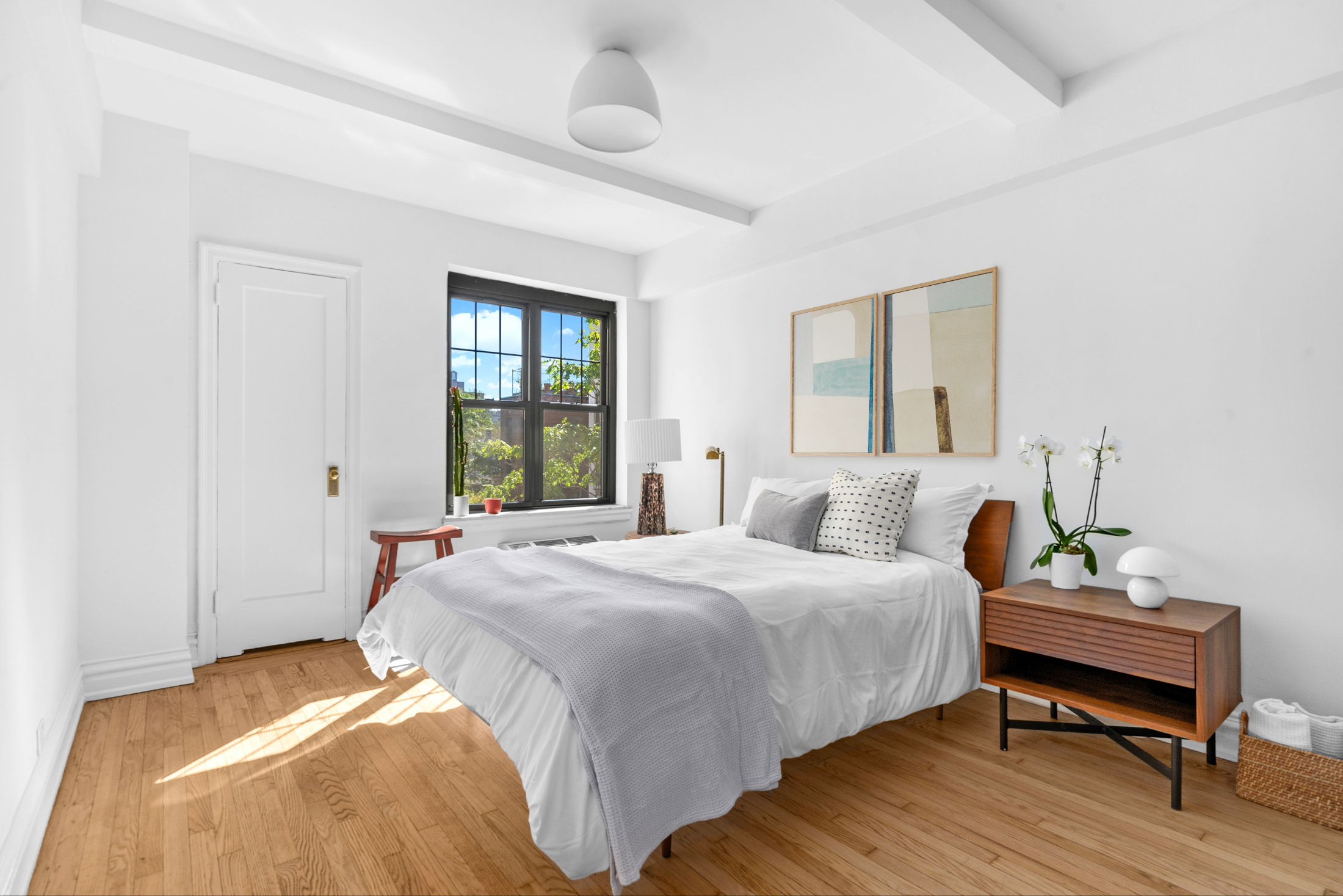 200 East 16th Street, Unit 5D Manhattan, NY 10003 - Photo 5 of 7 a bedroom with a bed table and window