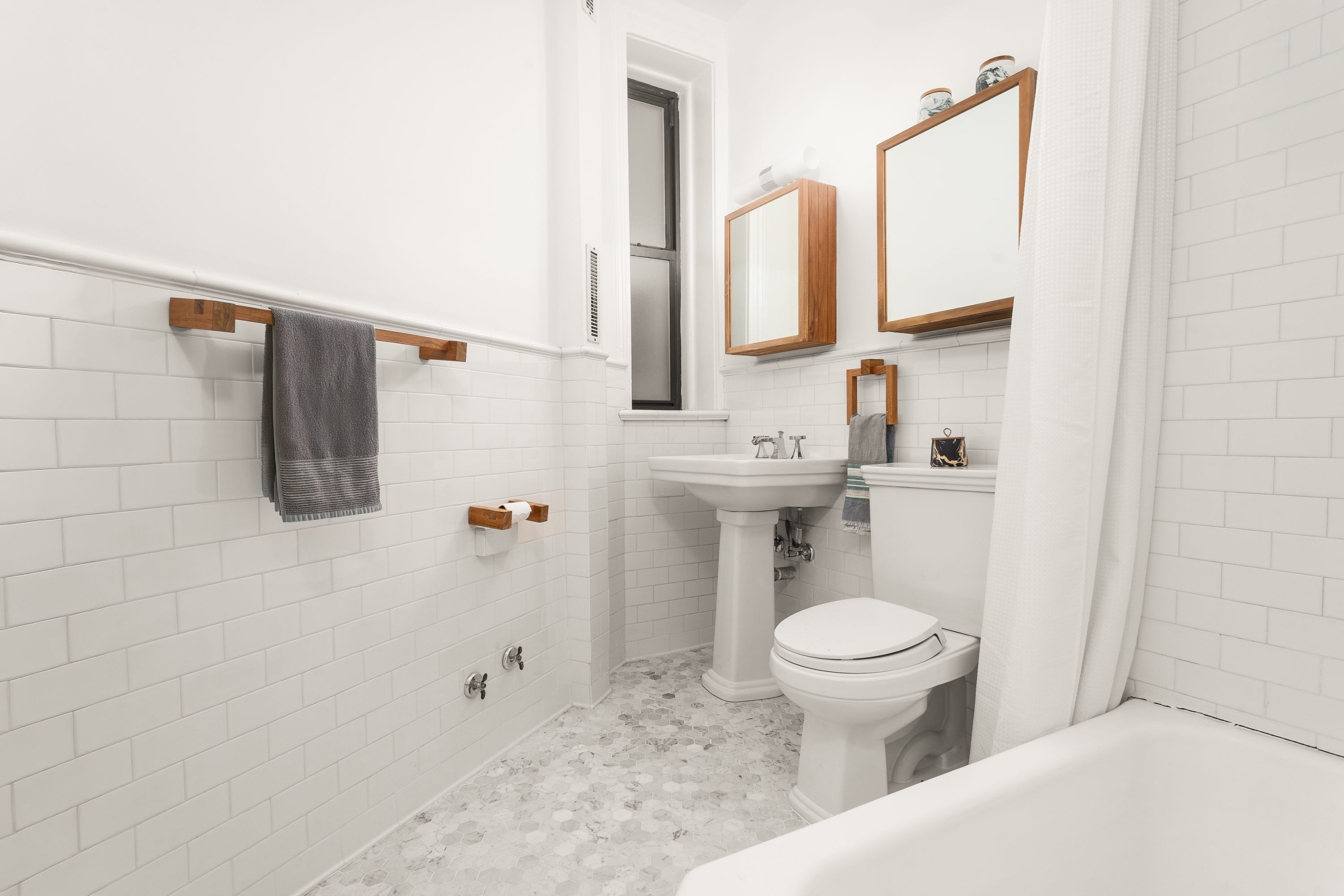 292 Riverside Drive, Unit 3C Manhattan, NY 10025 - Photo 6 of 9 a bathroom with a toilet sink and mirror