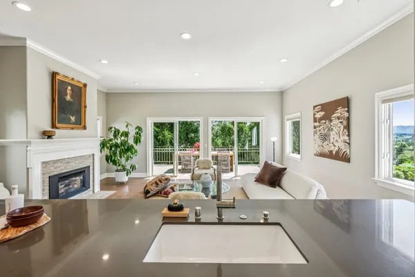 a living room with furniture a fireplace and a large window