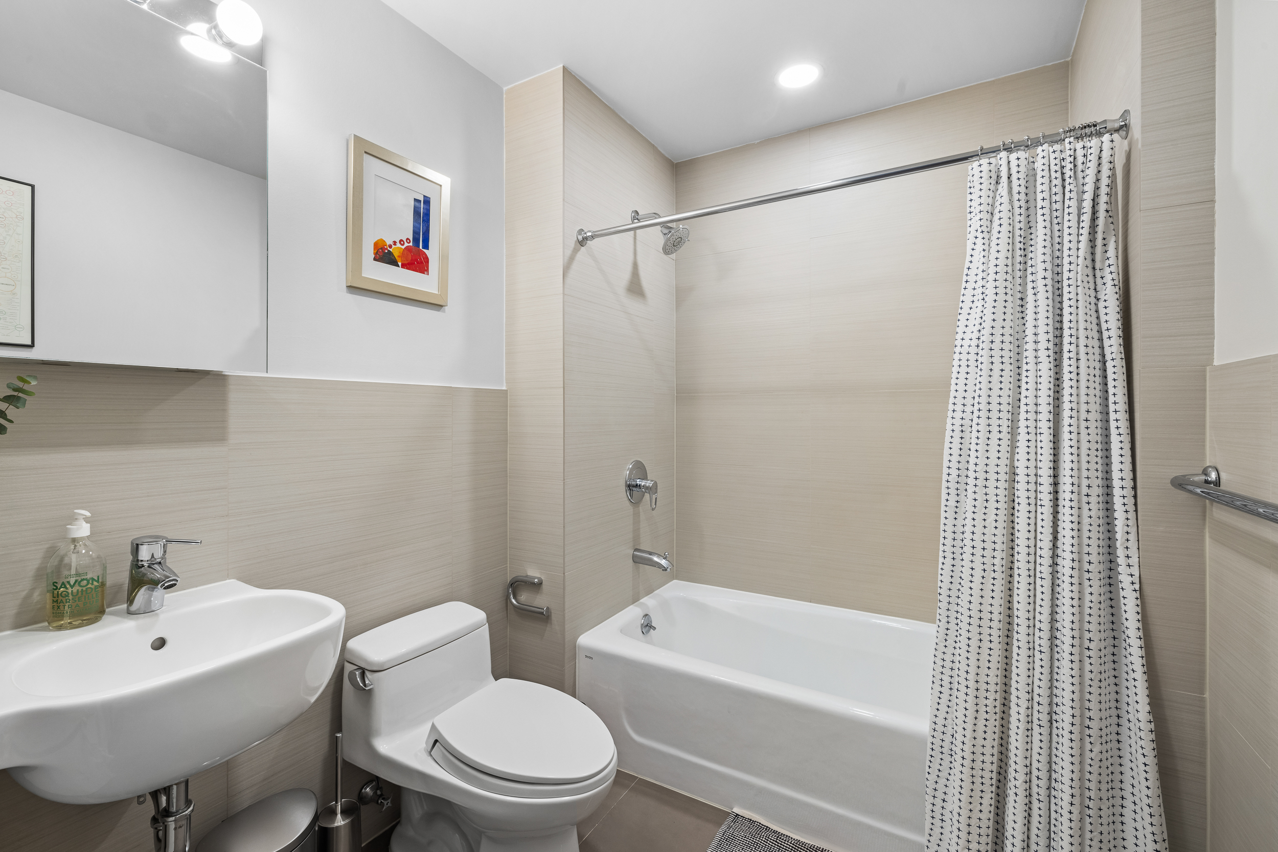 20 Tiffany Place, Unit 6N Brooklyn, NY 11231 - Photo 9 of 12 a bathroom with a toilet a sink and a bathtub