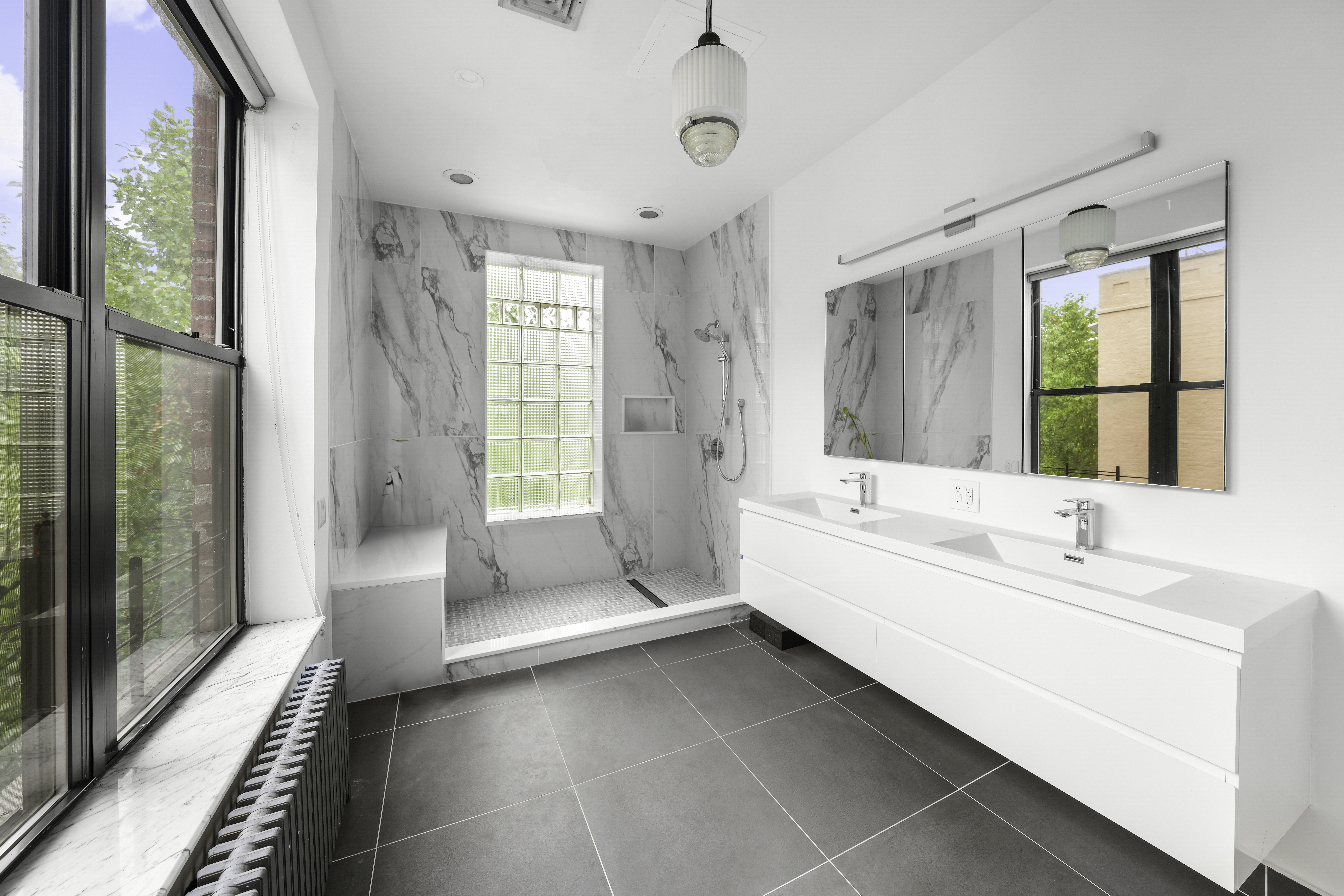 109 West 118th Street Manhattan, NY 10026 - Photo 20 of 31 a spacious bathroom with a tub sink and mirror