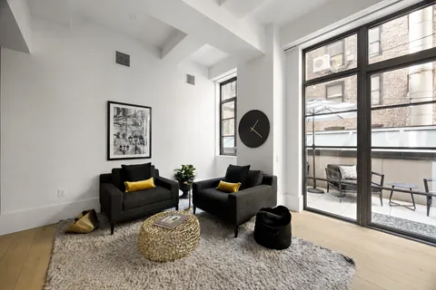 a living room with furniture and a floor to ceiling window
