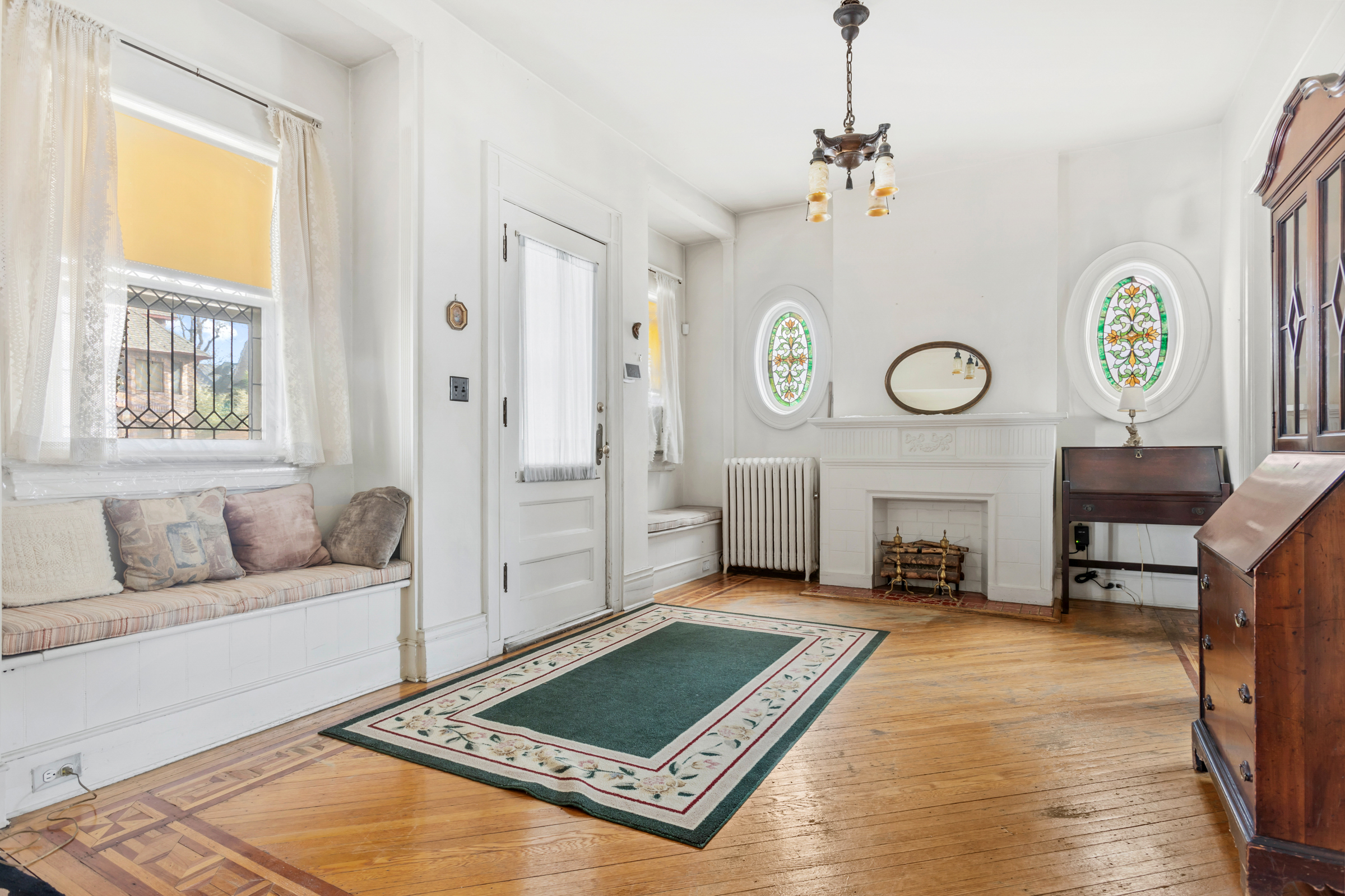 686 Rugby Road Brooklyn, NY 11230 - Photo 4 of 18 a living room with furniture a window and a fireplace