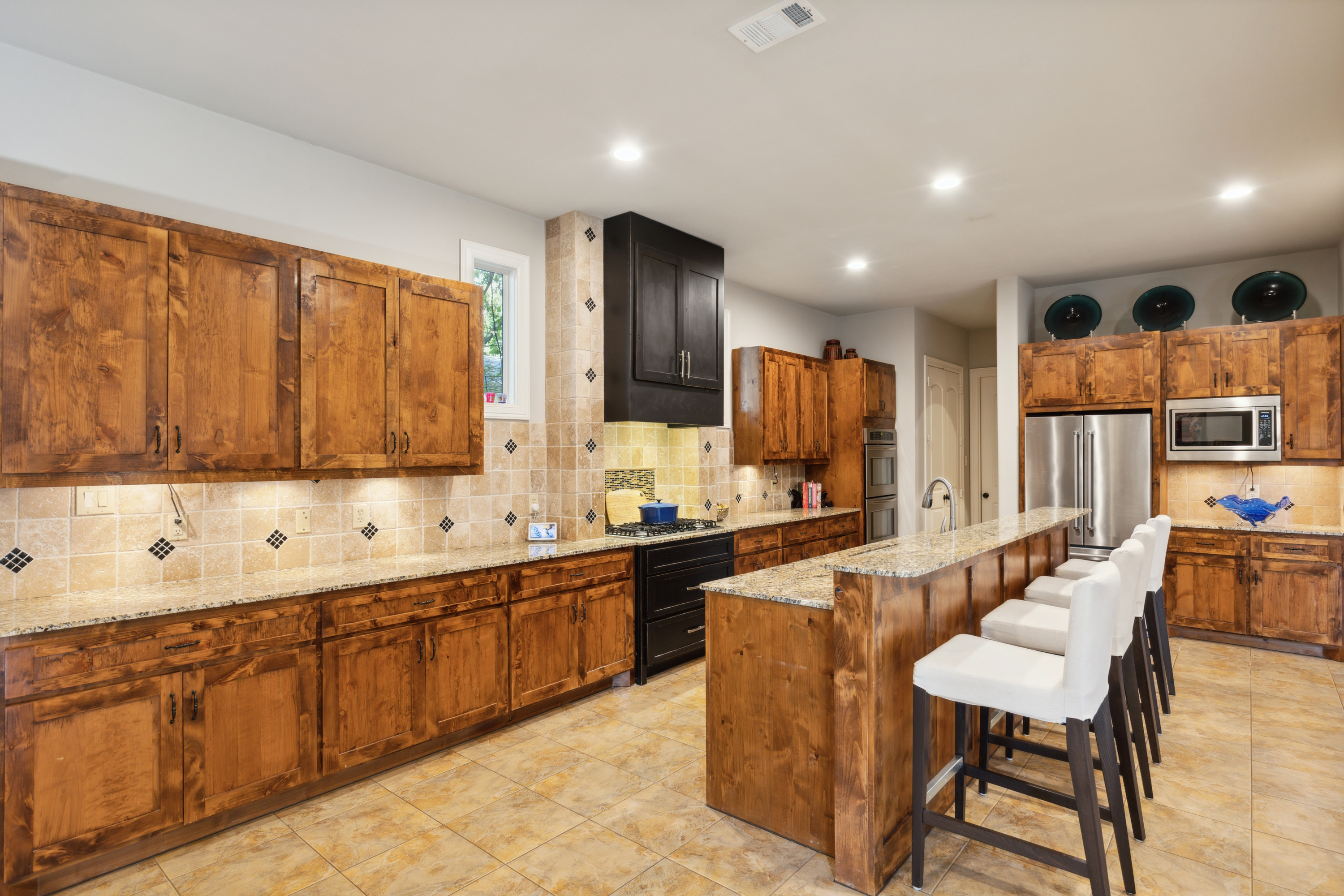 8411 Midway Road Dallas, TX 75209 - Photo 13 of 29 a large kitchen with lots of counter space and sink