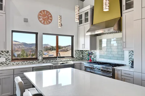 a bathroom with a glass shower door a sink and a bathtub