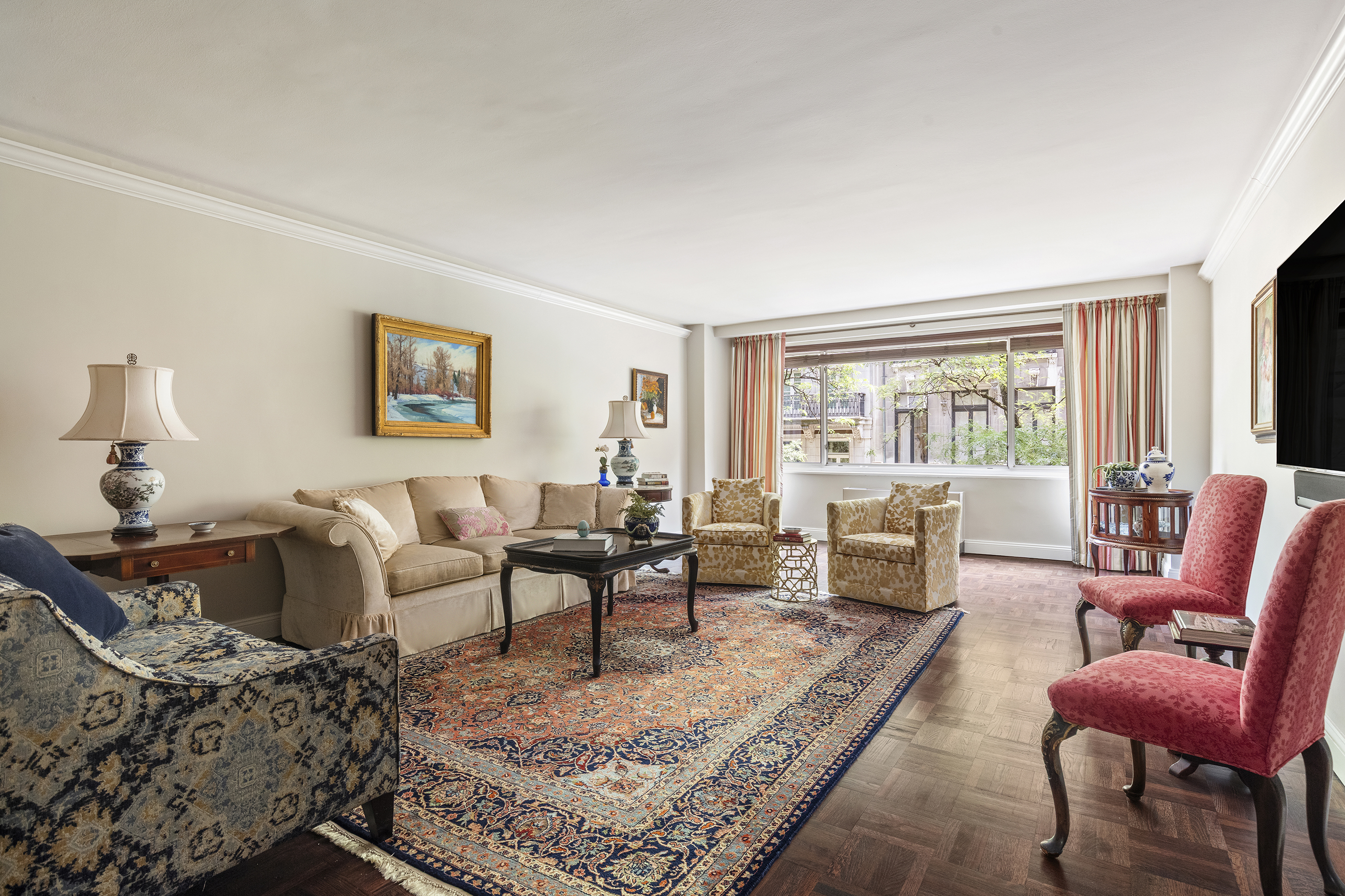 10 East 70th Street, Unit 3A Manhattan, NY 10021 - Photo 1 of 18 a living room with furniture couches and a large window