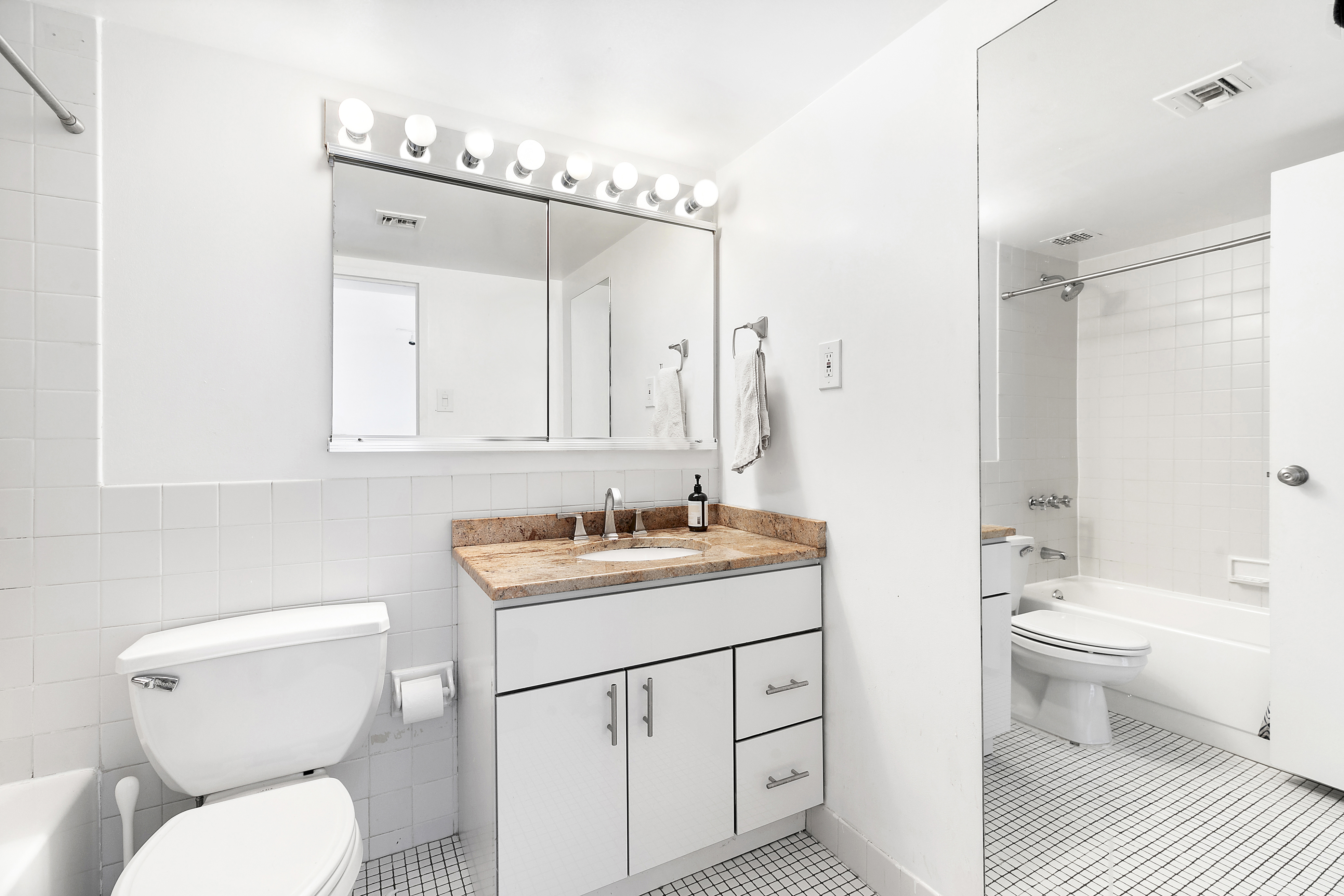 253 West 73rd Street, Unit 8G Manhattan, NY 10023 - Photo 5 of 5 a bathroom with a toilet sink and mirror