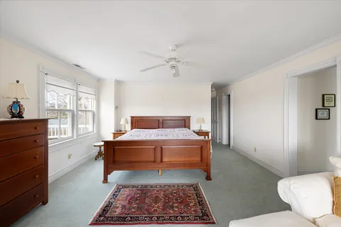 a spacious bedroom with a large bed and a large window