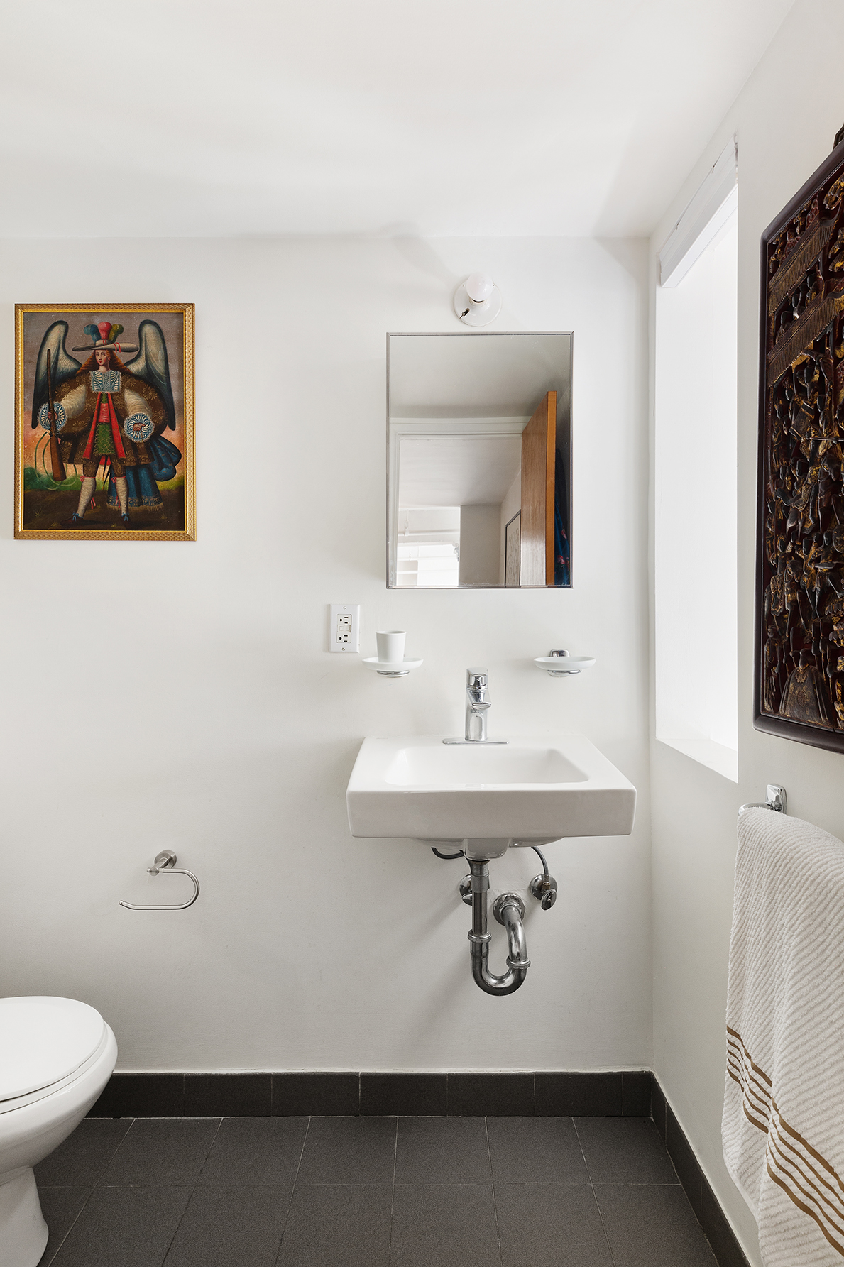 135 Greene Street, Unit 2N Manhattan, NY 10012 - Photo 10 of 13 a bathroom with a sink mirror and toilet
