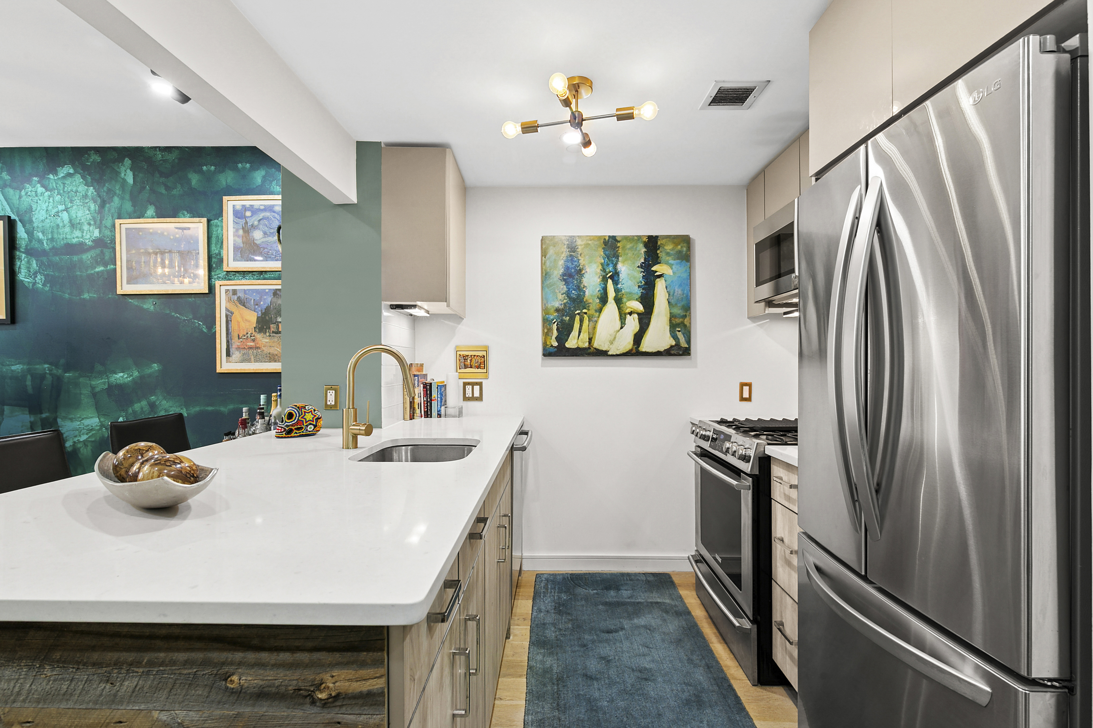 171 West 131st Street, Unit 303 Manhattan, NY 10027 - Photo 3 of 11 a kitchen with stainless steel appliances a microwave a sink and a refrigerator