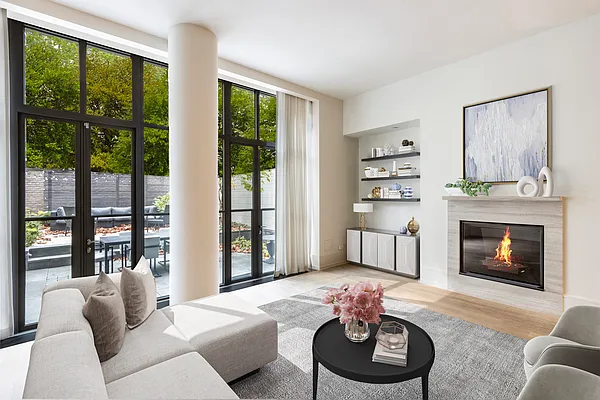 215 Sullivan Street, Unit THC Manhattan, NY 10012 - Photo 1 of 16 a living room with furniture and a fireplace