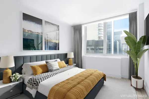 a bedroom with a bed and a potted plant