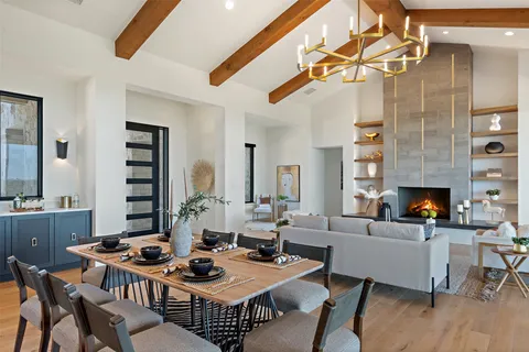 a living room with furniture a fireplace and a table