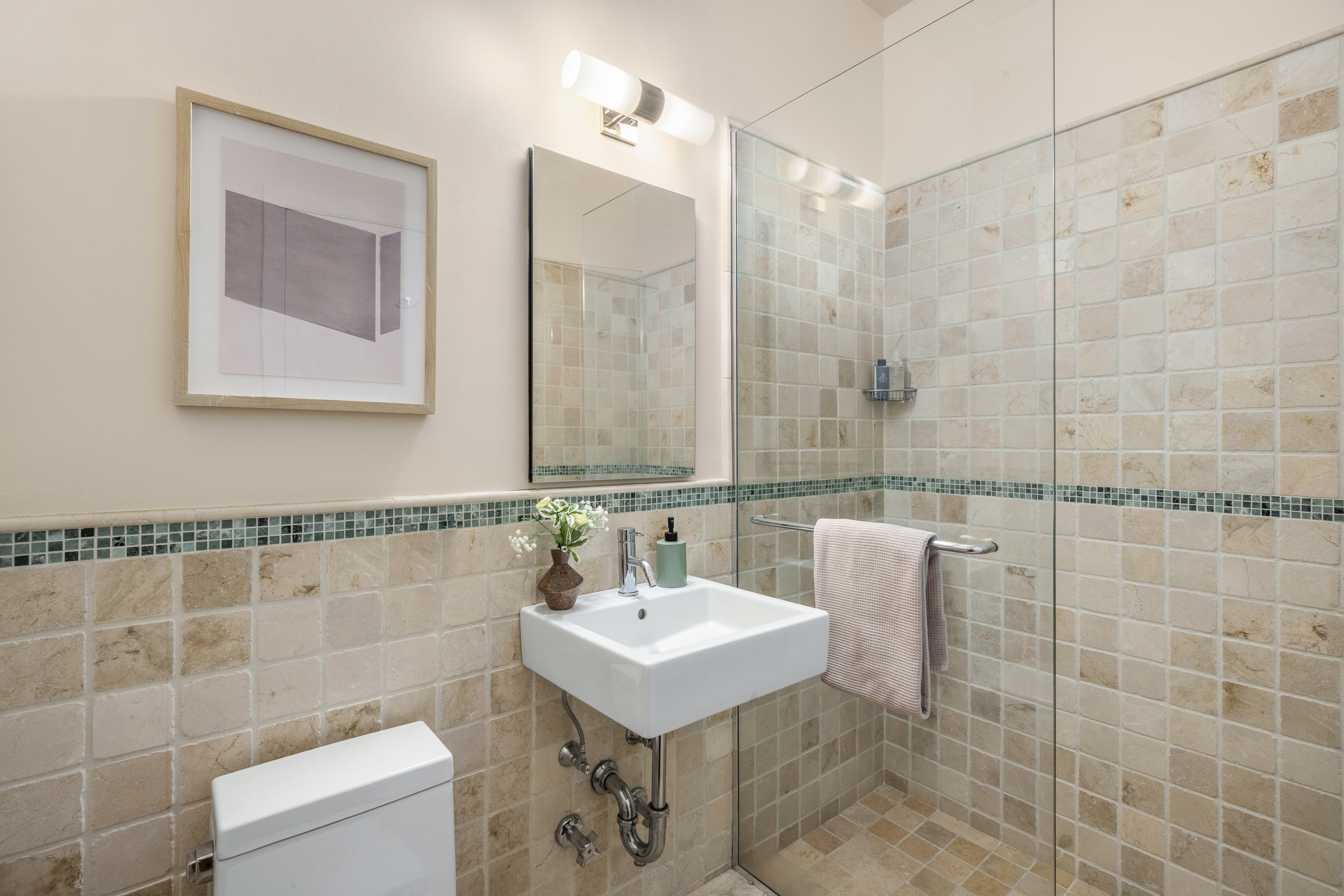 175 East Broadway, Unit 7A Manhattan, NY 10002 - Photo 21 of 24 a bathroom with a sink a toilet and shower