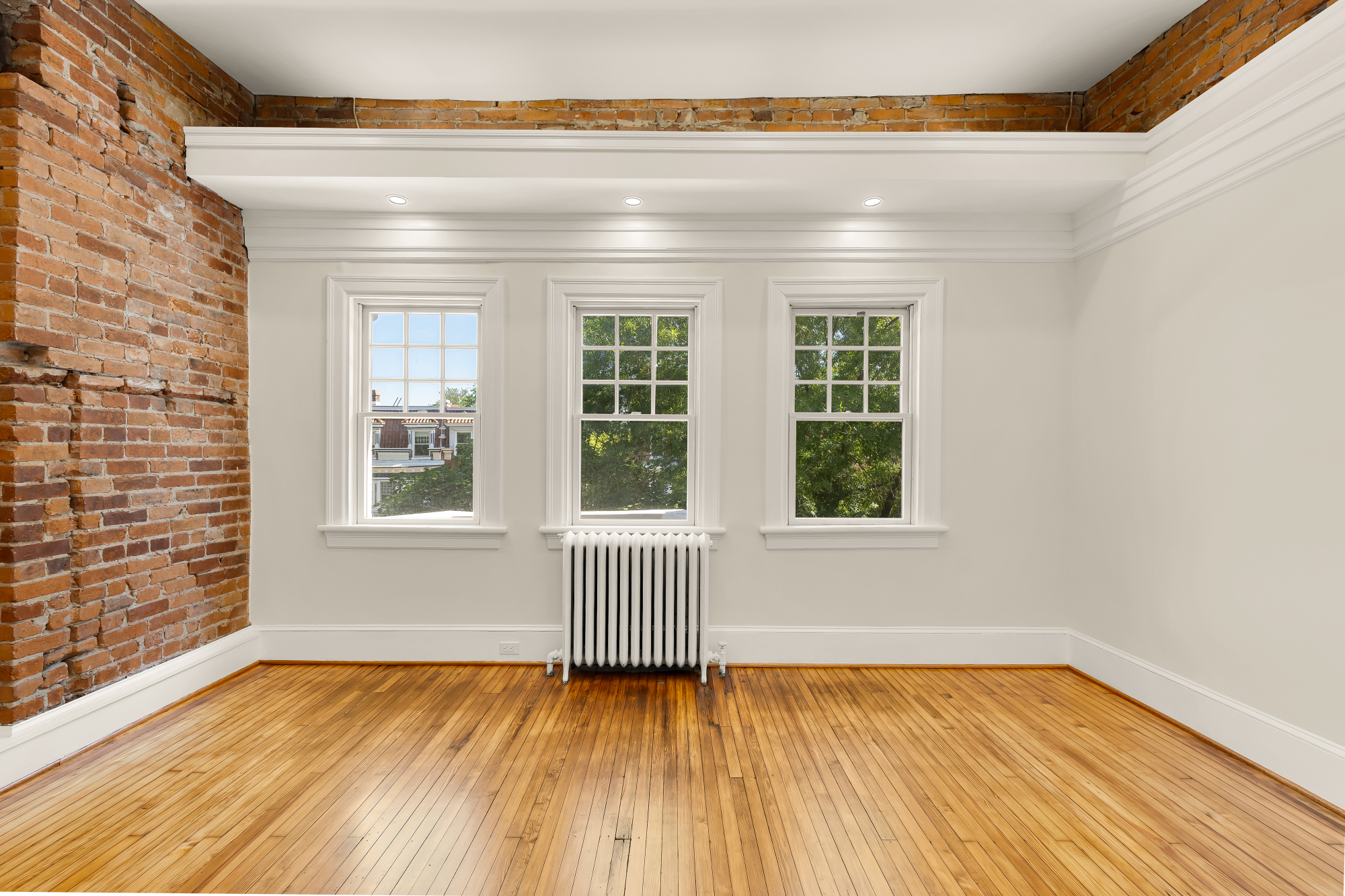 1737 Park Road Northwest Washington, DC 20010 - Photo 15 of 32 a view of an empty room with wooden floor and a window
