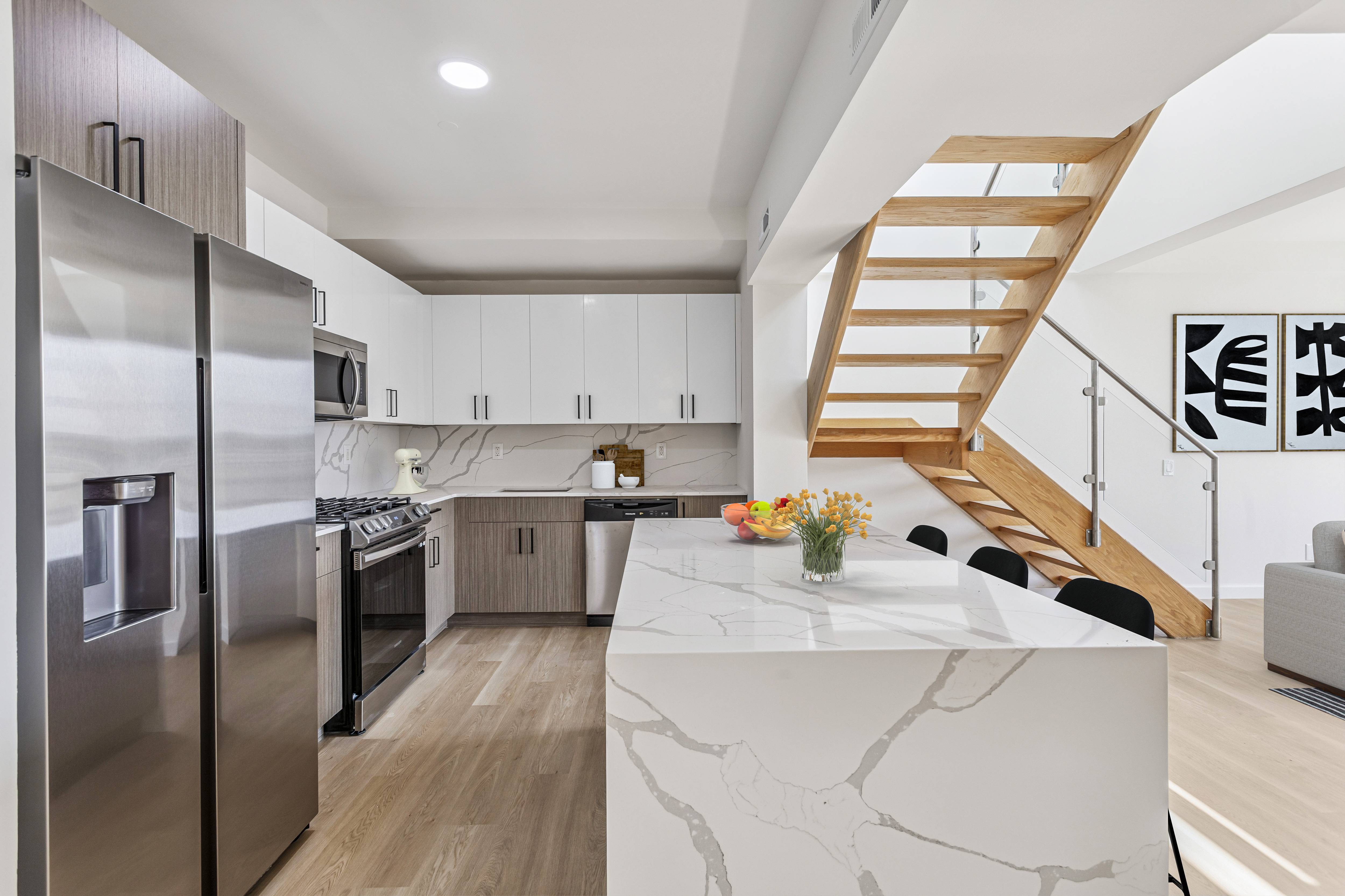 3112 Emmons Avenue, Unit 307 Brooklyn, NY 11235 - Photo 2 of 13 a kitchen that has a lot of cabinets a sink and appliances in it