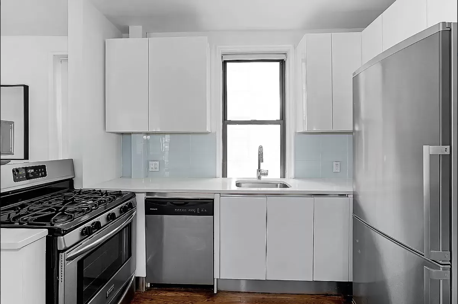 245 West 25th Street, Unit 1P Manhattan, NY 10001 - Photo 2 of 13 a kitchen with a stove a refrigerator and a sink