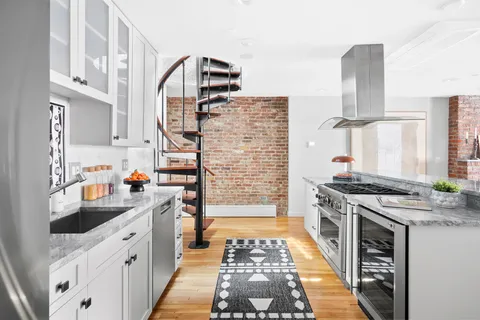 a kitchen with stainless steel appliances granite countertop a stove and a sink
