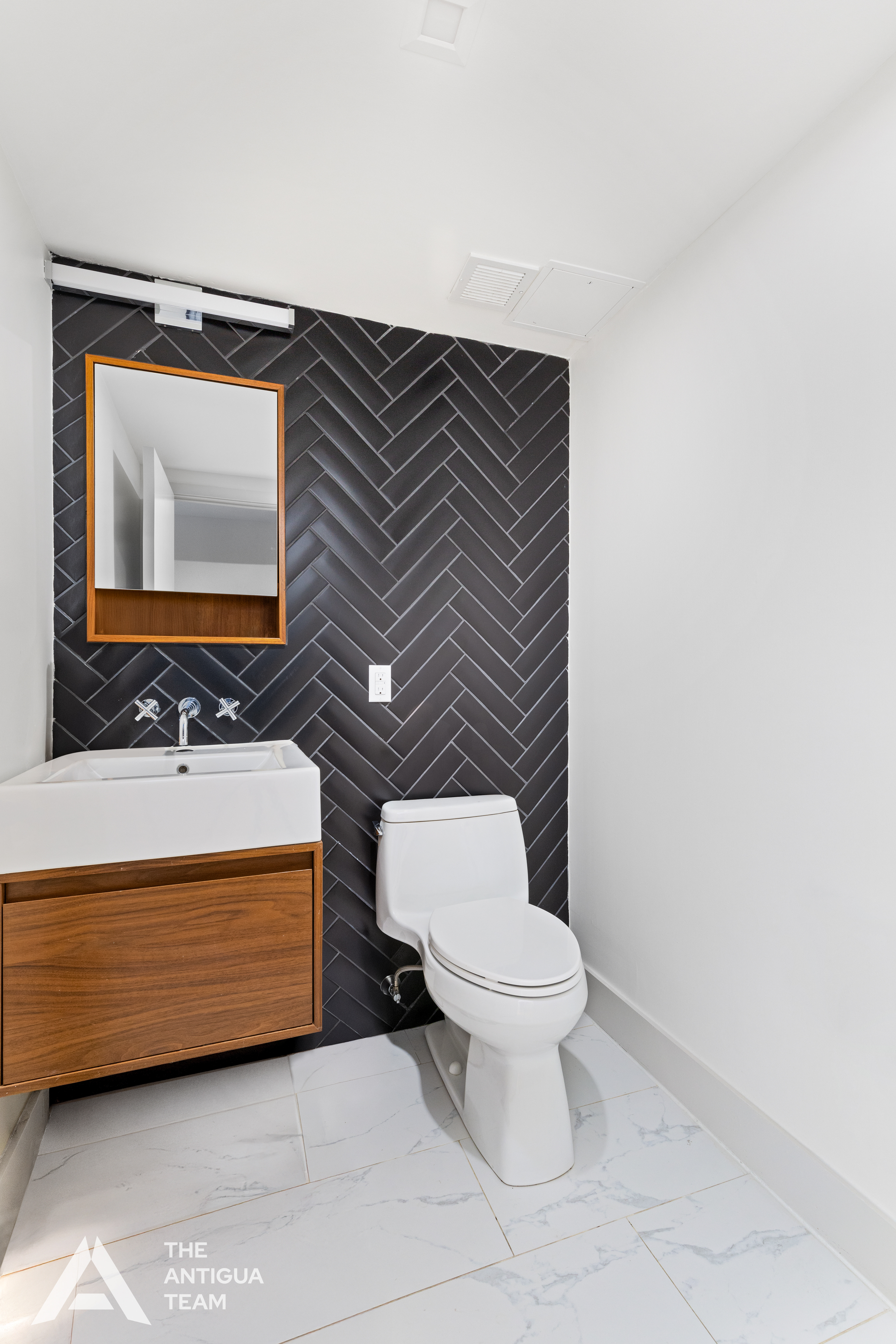 167 Eagle Street, Unit 1B Brooklyn, NY 11222 - Photo 8 of 13 a bathroom with a toilet a sink and mirror