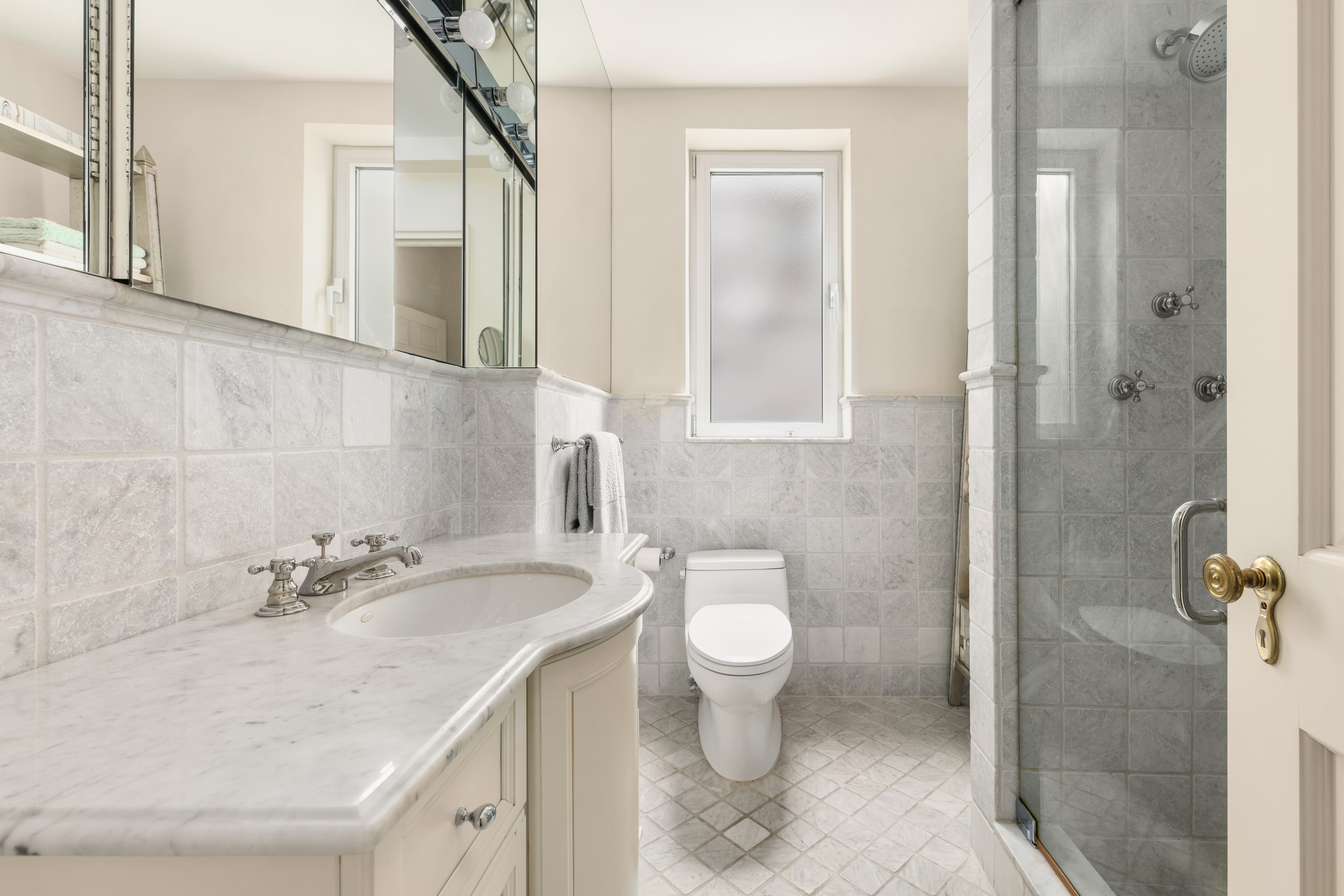 1 East 66th Street, Unit 9EF Manhattan, NY 10065 - Photo 15 of 19 a bathroom with a sink toilet and shower
