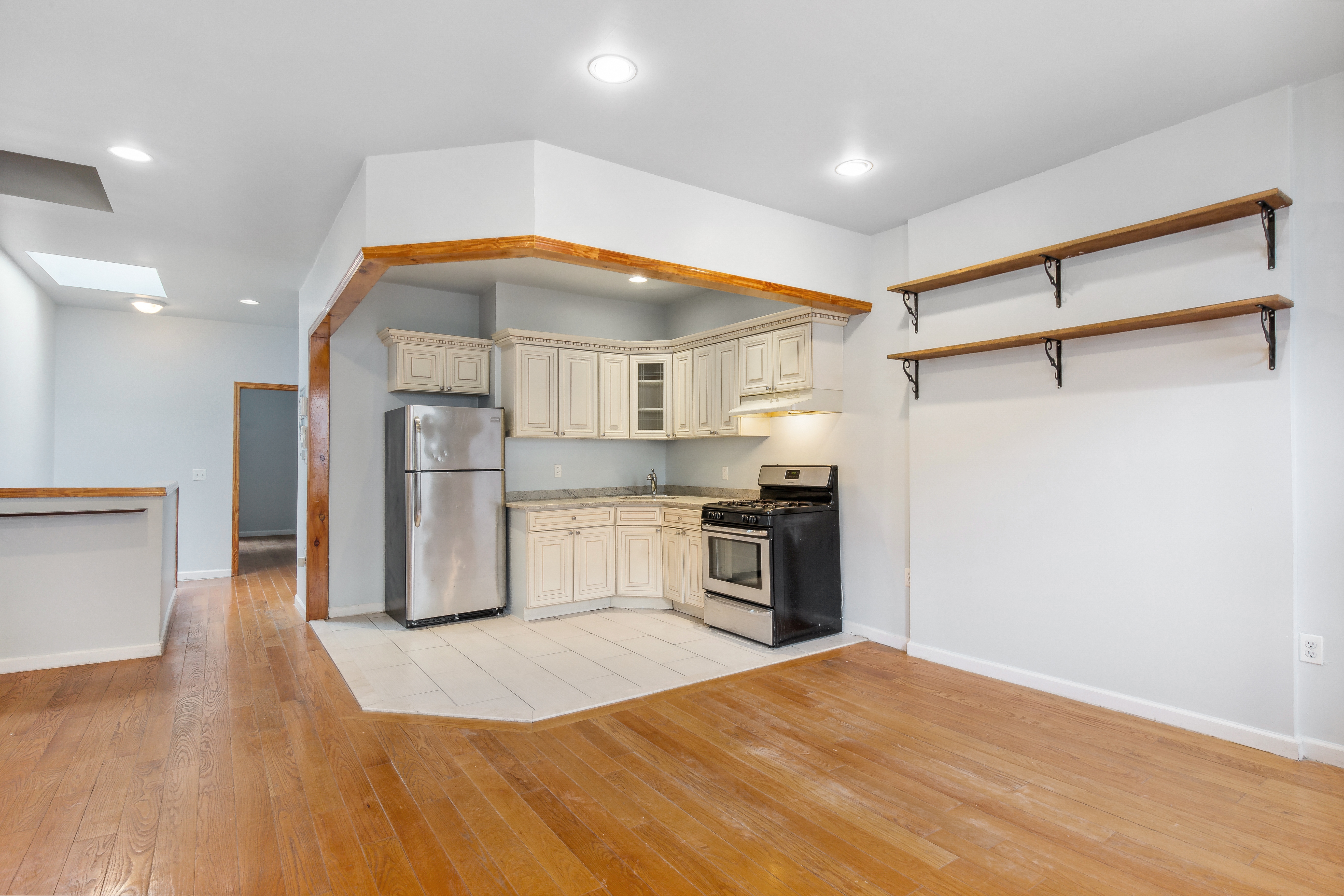 530 West 175th Street, Unit 2 Manhattan, NY 10033 - Photo 5 of 12 a kitchen with stainless steel appliances kitchen island granite countertop a refrigerator and a stove top oven
