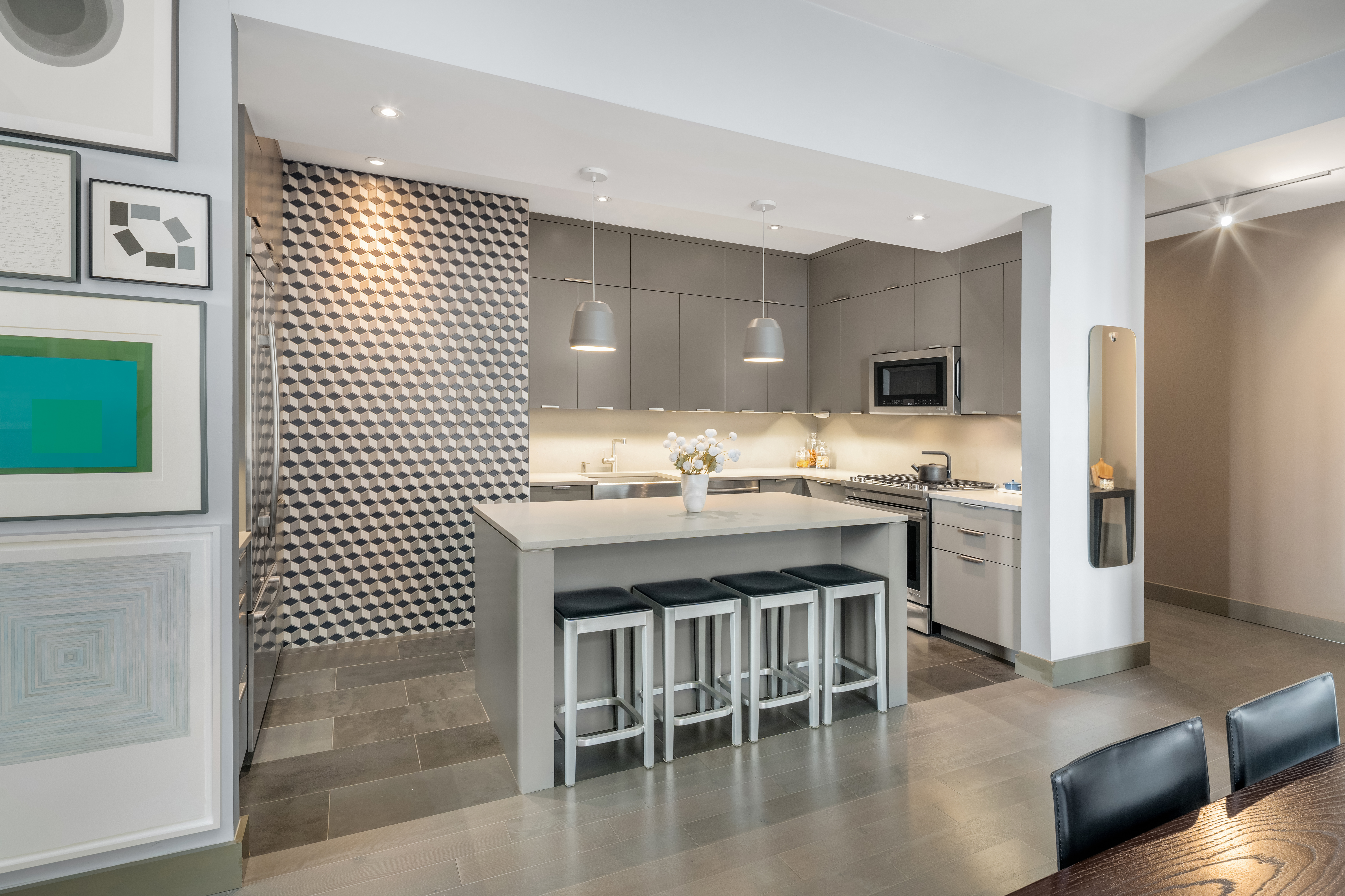 252 7th Avenue, Unit 9D Manhattan, NY 10001 - Photo 8 of 23 a kitchen with a sink dishwasher a stove and a refrigerator with wooden floor
