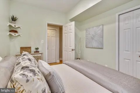 a bedroom with a bed and a lamp