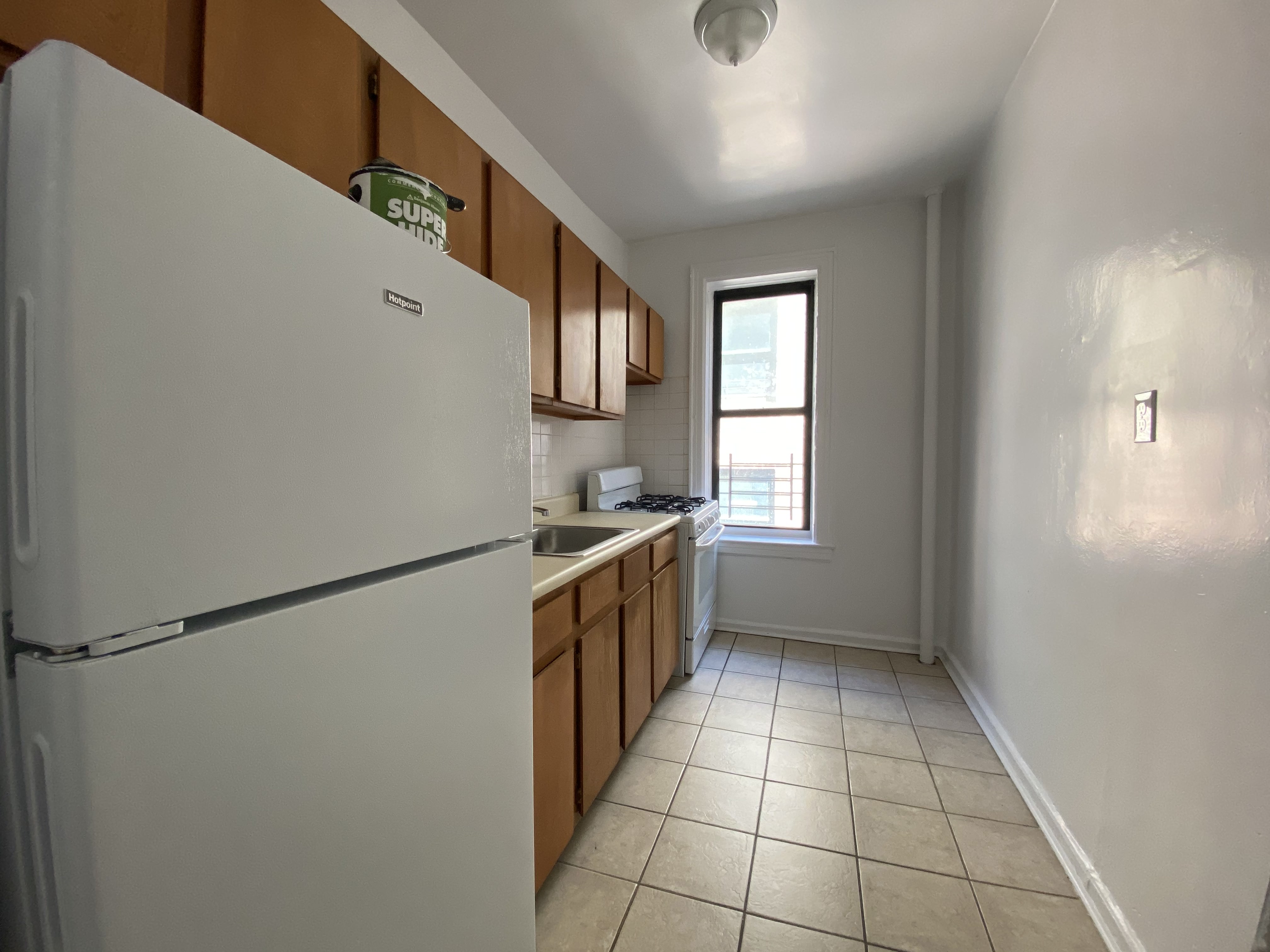 28-23 42nd Street, Unit C3 Queens, NY 11103 - Photo 3 of 6 a kitchen with stainless steel appliances granite countertop a sink and a stove top oven