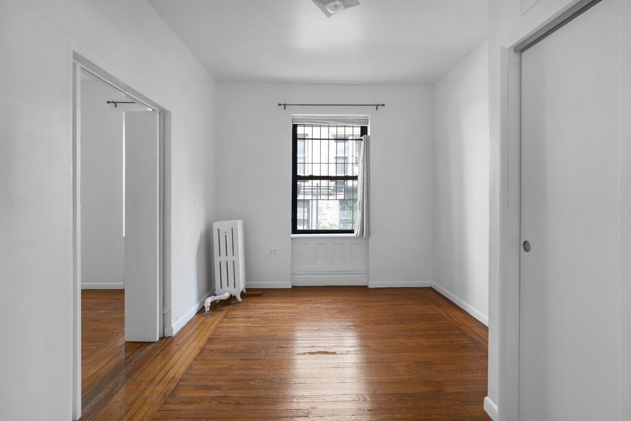 507 West 111th Street, Unit 3 Manhattan, NY 10025 - Photo 7 of 11 a view of empty room with wooden floor and fan