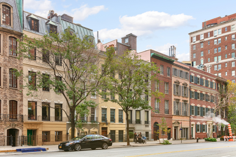 16 Sutton Place, Unit 11A Manhattan, NY 10022 - Photo 16 of 19 a front view of a building with lot of cars and trees