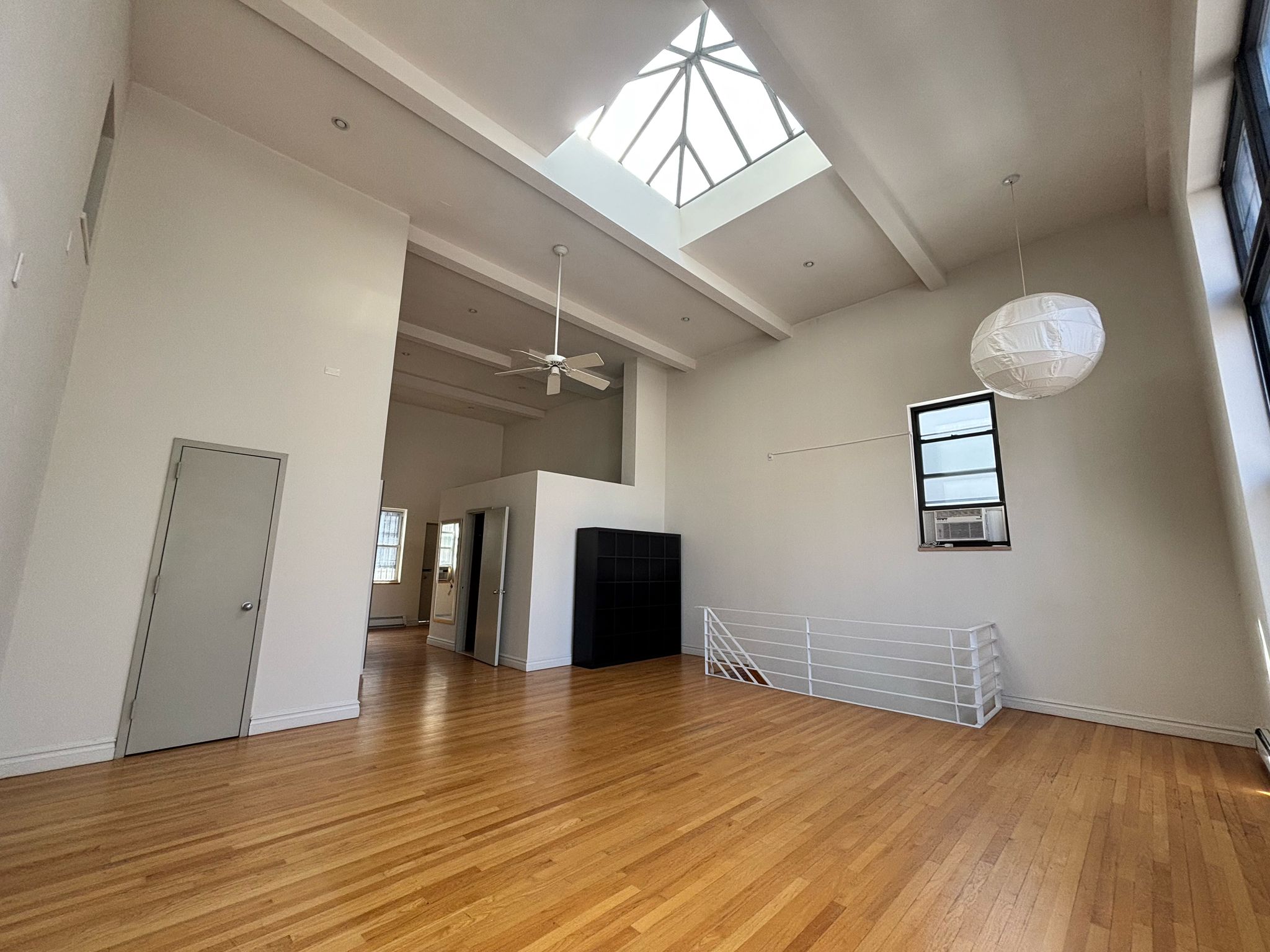 85 Division Street, Unit 4 Manhattan, NY 10002 - Photo 18 of 22 wooden floor in an empty room with a window