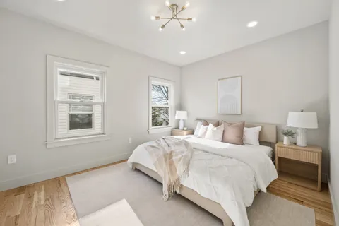 a spacious bedroom with a large bed and a window