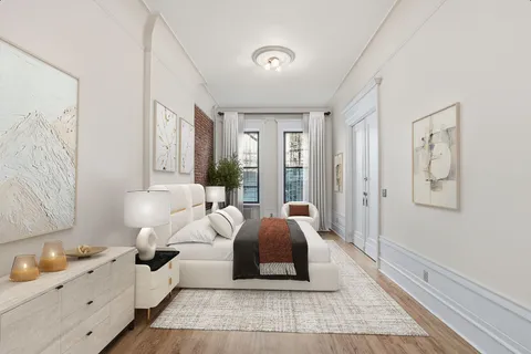 a spacious bedroom with a bed and a large window