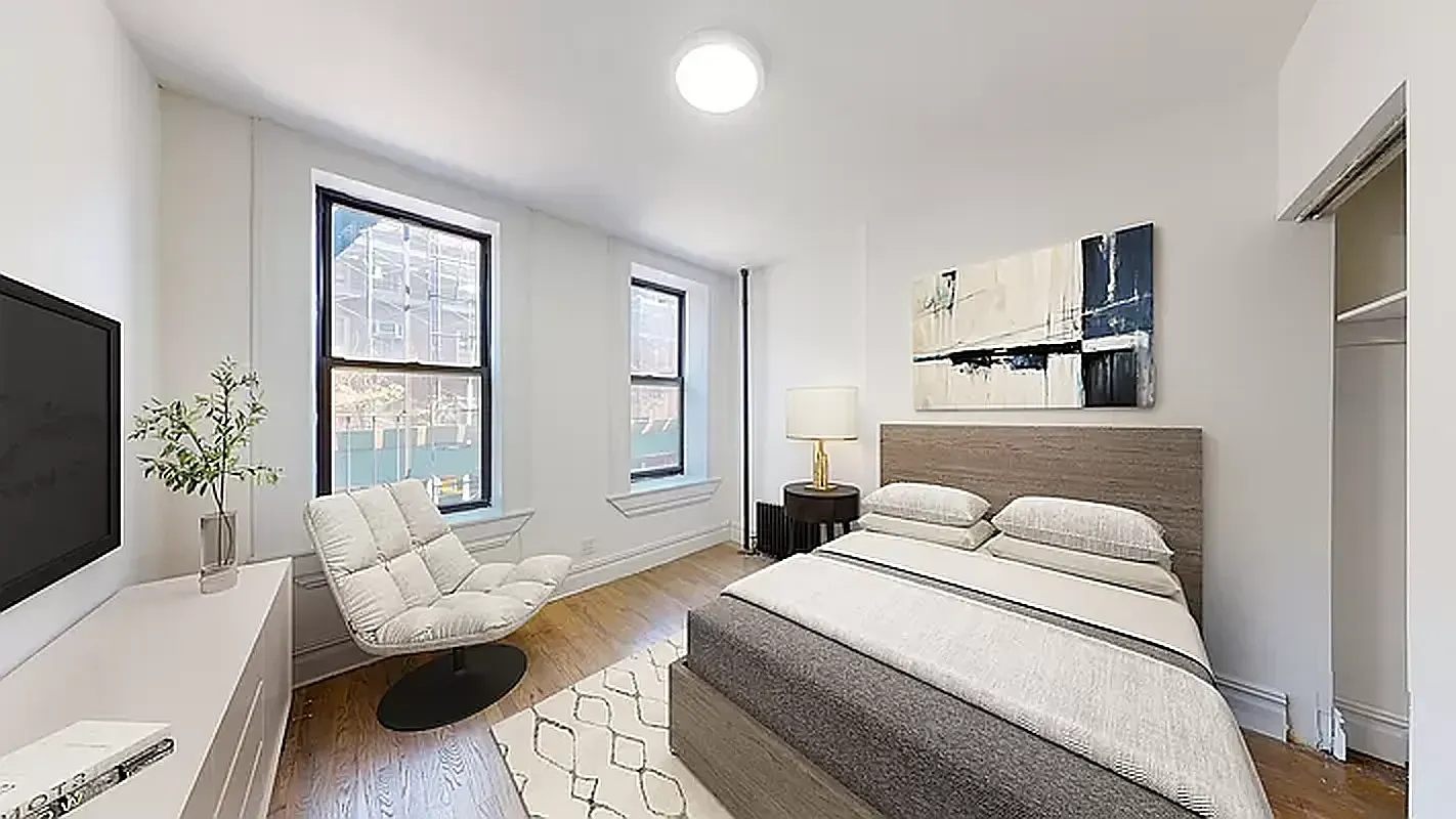 545 East 5th Street, Unit 3 Manhattan, NY 10009 - Photo 2 of 4 a bedroom with a bed and a couch