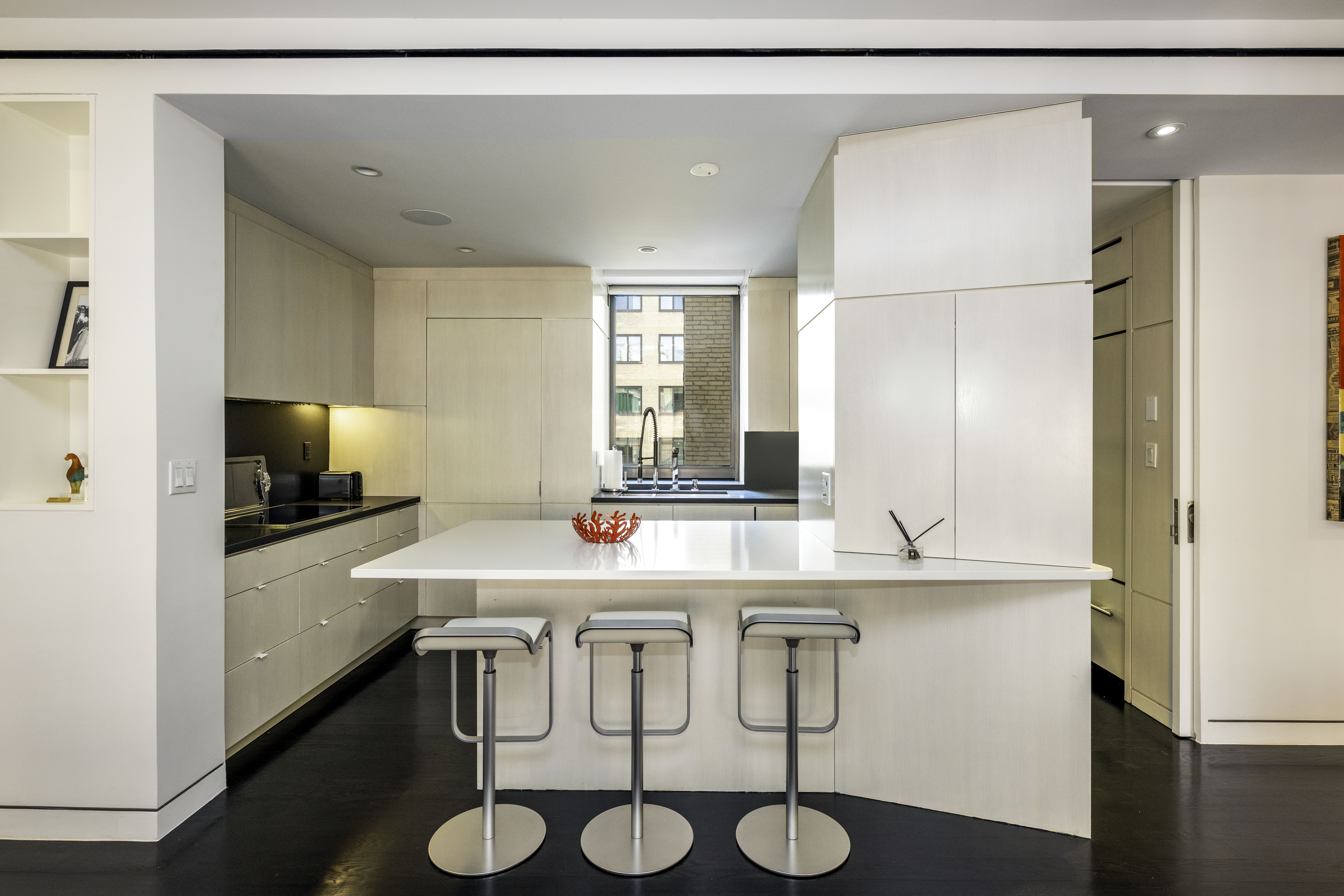 40 East 62nd Street, Unit 8E Manhattan, NY 10065 - Photo 7 of 24 a kitchen with stainless steel appliances a sink and a refrigerator