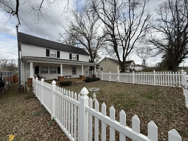 a view of a house with wooden fence
