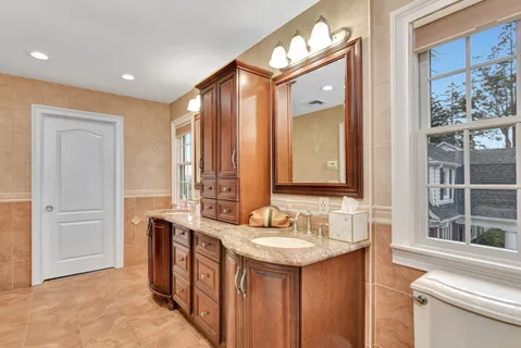 a bathroom with a double vanity sink and a mirror