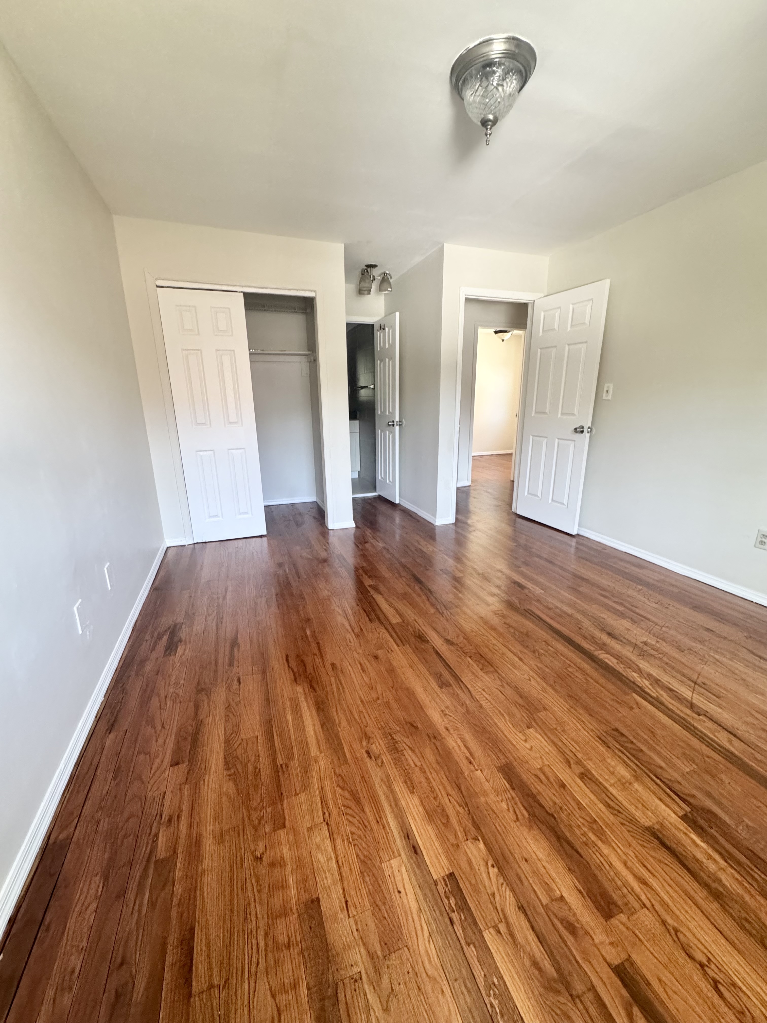 156-17 76th Street, Unit 1 Queens, NY 11414 - Photo 4 of 12 a view of a room with wooden floor and staircase