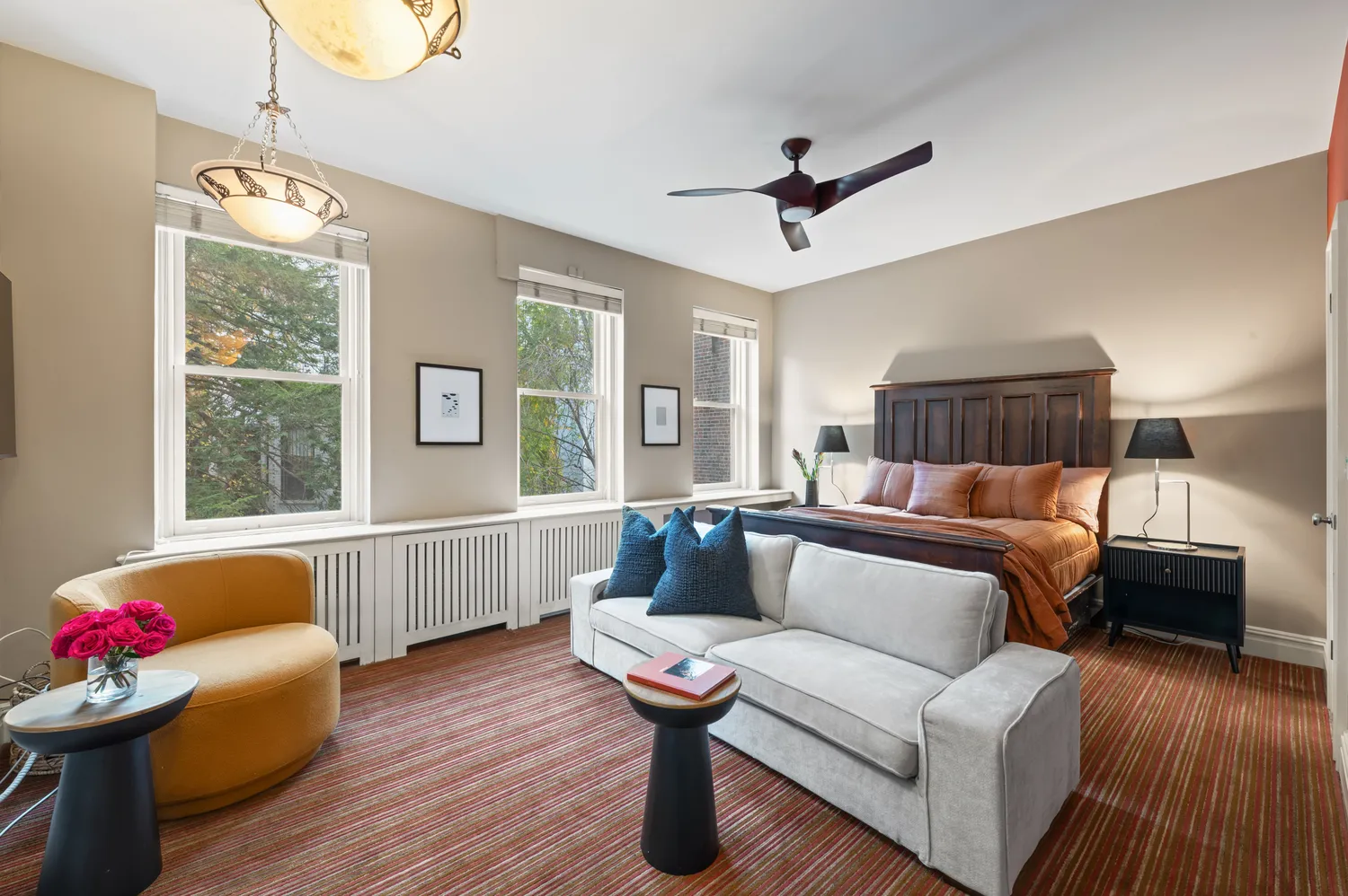 a living room with furniture and a wooden floor